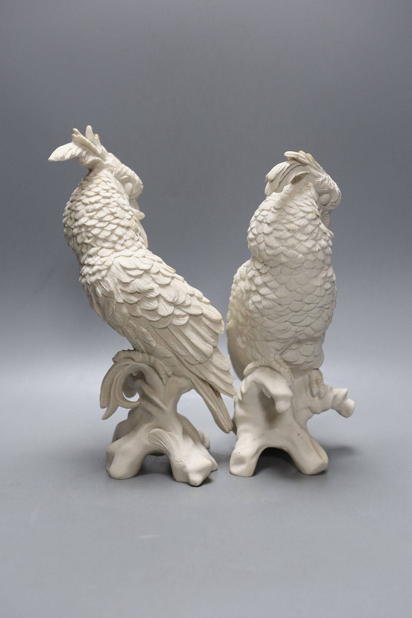 A pair of white resin cockatiels - 28cm tall